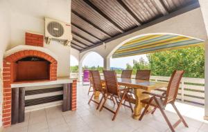 a patio with a table and chairs and a fireplace at Apartments Vesna in Pinezici +124 photos