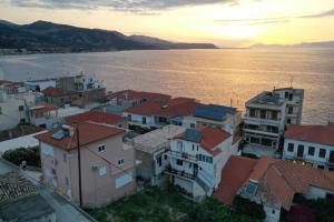 a group of buildings next to a body of water at Family Apartment in Derveni