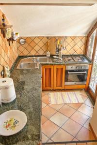 a small kitchen with a sink and a stove at Villa Santa Sofia in Vico Equense