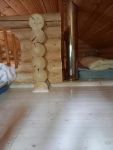 a room with a wooden wall with a clock on it at Ellu in Kangasniemi