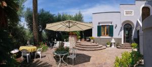 a patio with a table and an umbrella at Villa Santa Sofia - Italian Escape in Vico Equense