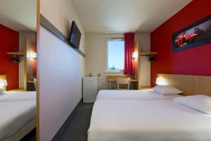 Postelja oz. postelje v sobi nastanitve Enzo Hotels Nancy Frouard by Kyriad Direct