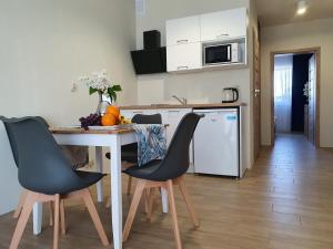 a kitchen with a table and chairs in a kitchen at Apartamenty Mieszko Rowy in Rowy