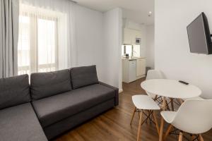 a living room with a couch and a table at Hotel Cidade de Olhão in Olhão