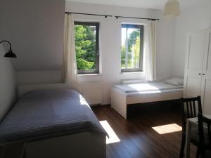 Cama ou camas em um quarto em Prokocim Apartments