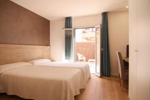 Postel nebo postele na pokoji v ubytování Hotel Bulevard