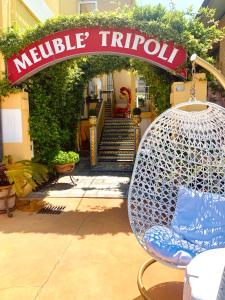 a sign that reads melville trudell in front of a building at Meublè Tripoli in Grado