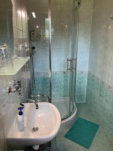 a bathroom with a sink and a shower at ALFA in Demanovska Dolina +42 photos