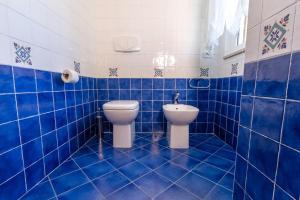 a blue tiled bathroom with a toilet and a bidet at Residence Palazzo Sayonara in Tortoreto Lido +81 photos