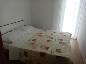מיטה או מיטות בחדר ב-Pave Apartment