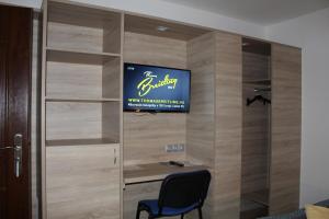 een televisie aan een muur in een kamer bij Czermann Holiday Inn in Oroszlány