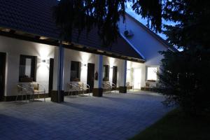 a group of chairs sitting outside of a building at Czermann Holiday Inn in Oroszlány