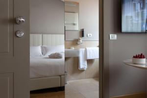 Voodi või voodid majutusasutuse Grand Hotel San Gemini I UNA Esperienze toas
