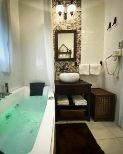a bathroom with a large bath tub with a sink at Apartment Kalina in Novi Sad