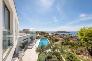 a view of the pool from the balcony of a house at Villa Marvela - Family 4 Bedroom in Maslinica