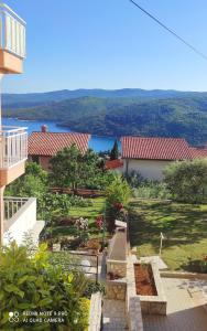 a view of a garden from a house at Studio Apartman Viktoria Rabac in Rabac