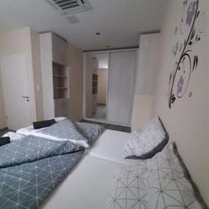 A bed or beds in a room at Vándor Vendégház