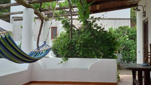 a hammock hanging from a ceiling in a garden at Agriturismo SoleMare in Stromboli