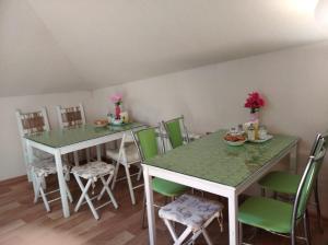 a dining room with a green table and chairs at Hostel Green Point in Kazan