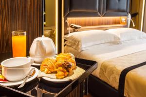 a hotel room with a tray of pastries and a bed at Hotel Lombardia in Florence