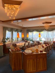 a dining room with a table and chairs and a room with at Hotel Sonnenhof in Bad Wildbad