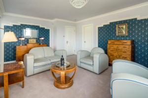 a living room with two chairs and a table at Burgh Island Hotel in Bigbury on Sea