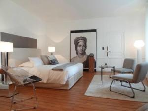 a bedroom with a bed with a painting of a man at BULLES DE LOIRE in Saumur