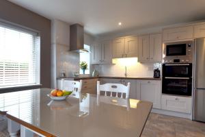 a kitchen with a table with a bowl of fruit on it at Hillcrest Luxury Apartment in Kilrush