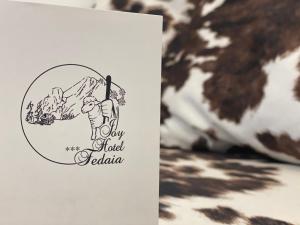 a card with a drawing of a cow and a mountain at Fedaia Joy B&B in Canazei