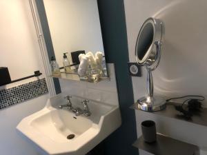 a bathroom with a sink and a mirror at BULLES DE LOIRE in Saumur +43 photos