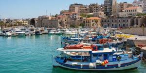 a group of boats are docked in a harbor at Koules Sea View City Apartment in Heraklio