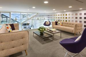 a living room with two couches and a table at Citadines Les Halles Paris in Paris