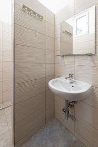 a bathroom with a sink and a mirror at East Station DeLuxe in Budapest