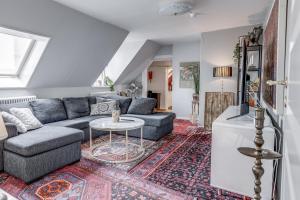a living room with a couch and a table at Cameo Boutique Hotell in Ystad