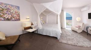 A bed or beds in a room at Pantokrator Hotel