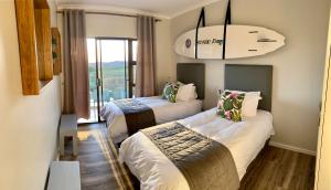 a hotel room with two beds and a chandelier at Santa Maria -Langebaan Country Estate in Langebaan