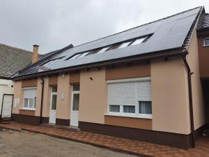 a house with solar panels on the roof at Kóbor Vendégház in Baja