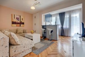 a living room with a couch and a table at Sun Apartments Marija in Budva