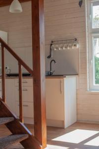 a kitchen with a staircase in a house at pod lipą in Ustka