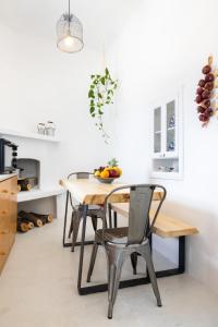 a kitchen with a wooden table and chairs at Nacros Villa Olympos Karpathou in Olympos +38 photos