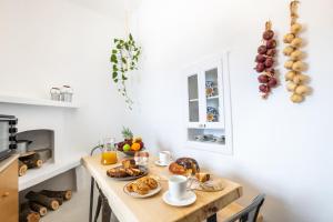 a kitchen with a table with breakfast foods on it at Nacros Villa Olympos Karpathou in Olympos