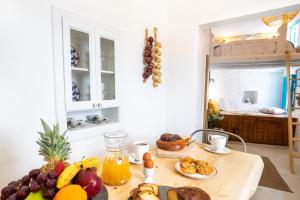 a table with fruit and juice on it in a kitchen at Nacros Villa Olympos Karpathou in Olympos
