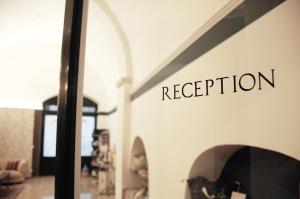 a sign on a wall that reads reception at Palazzo Bianchi - Trani in Trani