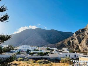 a view of a town with mountains in the background at Sabbia Calda 8 by Comfortbnb in Perissa