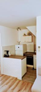 a small kitchen with white cabinets and a stove at Apartment Mira in Baška