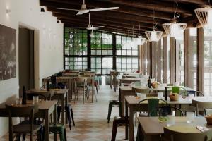 a restaurant with tables and chairs and windows at Camping & Residence Il Pioppeto in Vasto