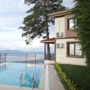 a house with a swimming pool next to a building at Orchid Hills in Sapanca