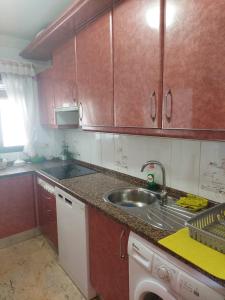 a kitchen with a sink and a counter top at Playa entre pinares in El Portil