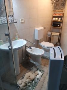 a bathroom with a toilet and a sink at La casa di Nina in San Giovanni la Punta