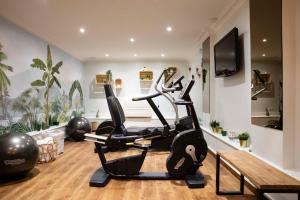 a gym with a treadmill and a bench at Hôtel Eiffel Saint Charles in Paris
